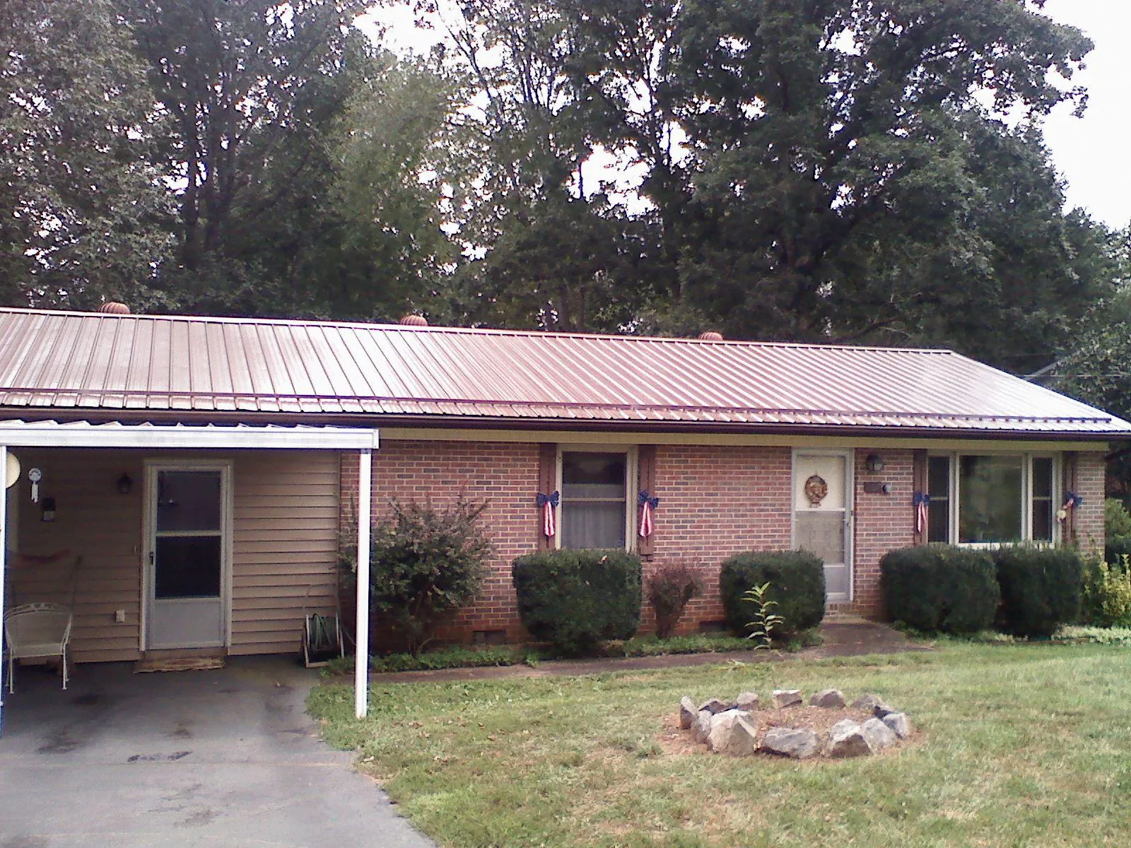 Bronze metal roof and carport on a brick ranch home — Roof Repair work by our crew in Fishkill